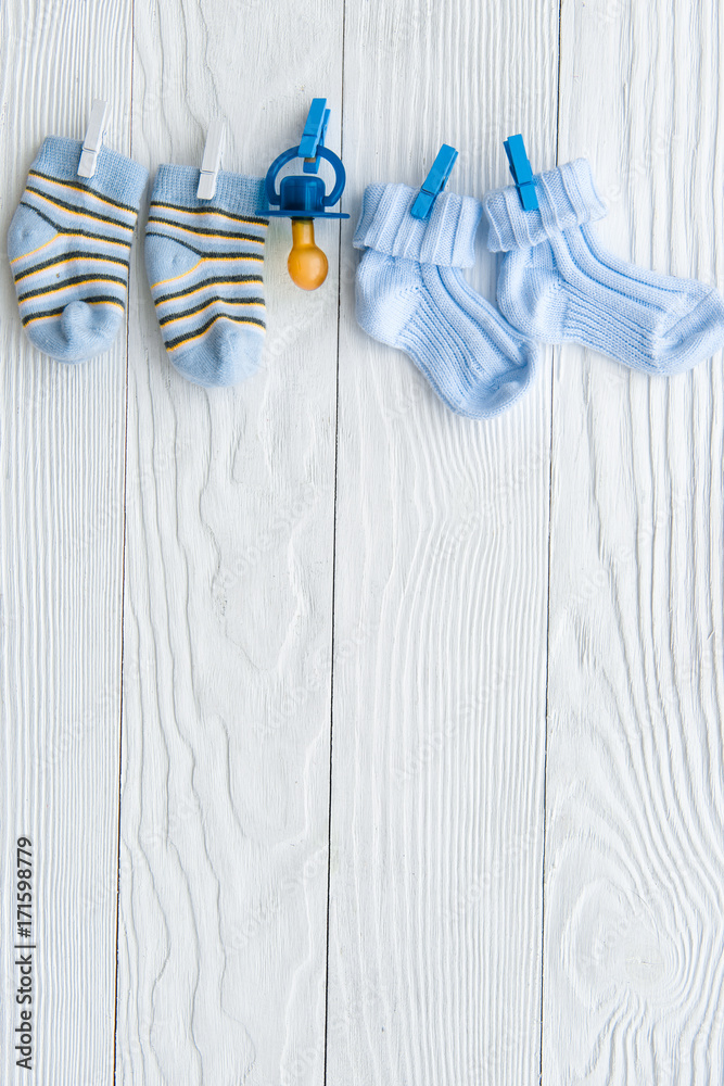 baby socks on rope at wooden background