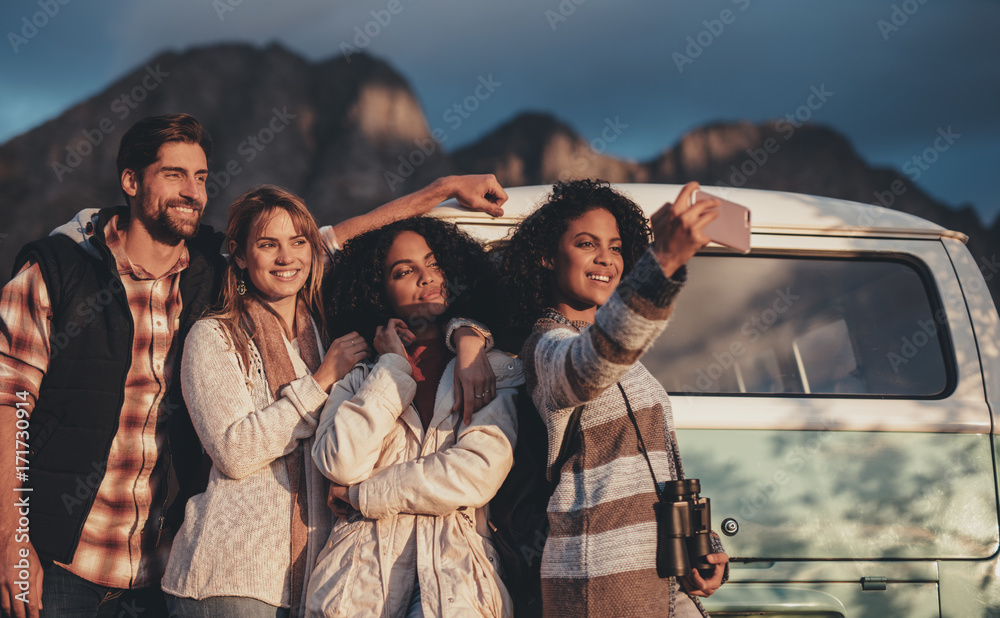 Friends on road trip taking selfie