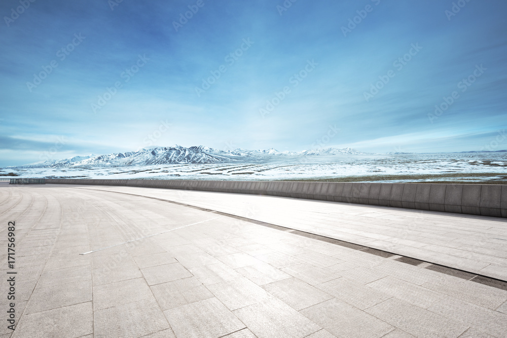 empty floor with beautiful snow mountains in blue sky