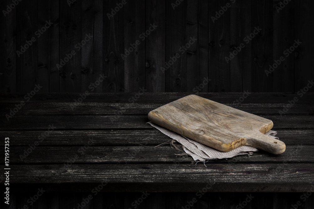 Dark wooden table for product, old black wooden perspective interior with old cutting board