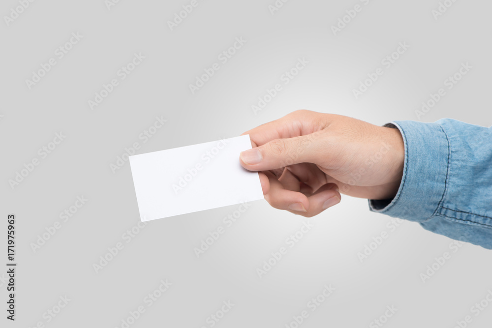 Male hand holding blank business card isolated