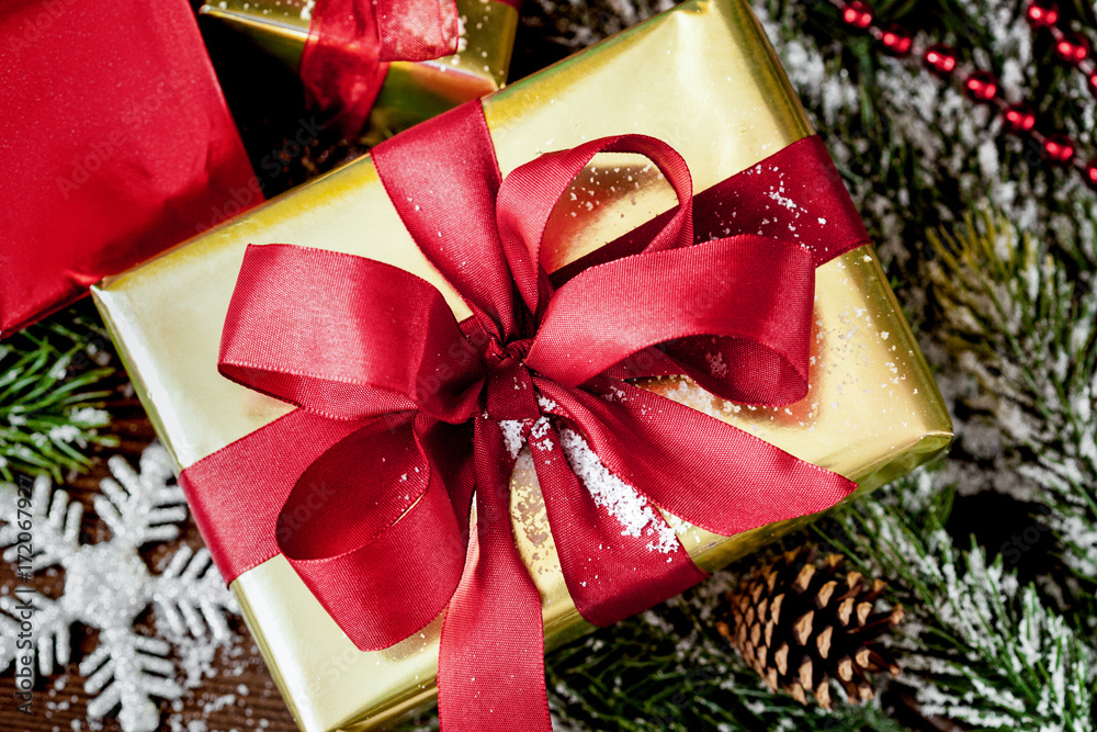 gifts boxes with fir branches on wooden background close up