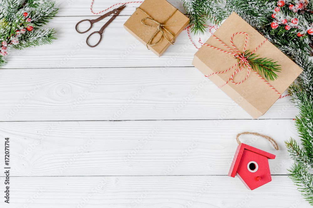 gifts boxes with fir branches on wooden background top view