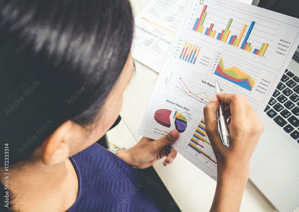 Businesswoman working in office, reading a financial report and documents during  business meeting, 