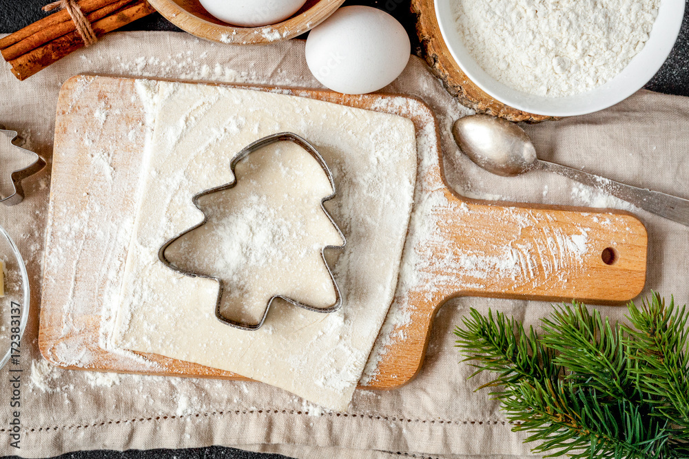 cooking christmas gingerbread on wooden background top view