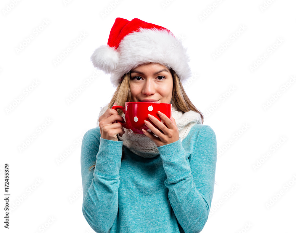 Happy young woman in winter clothes drinking coffee