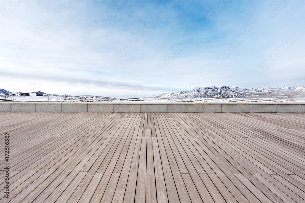 empty wooden floor with beautiful snow mountains