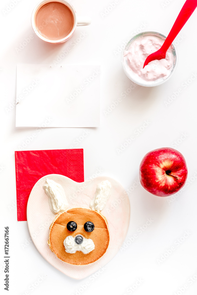 concept kid breakfast with pancake top view on white background