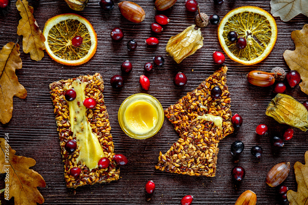 Autumn still life with honey and berries on wooden background