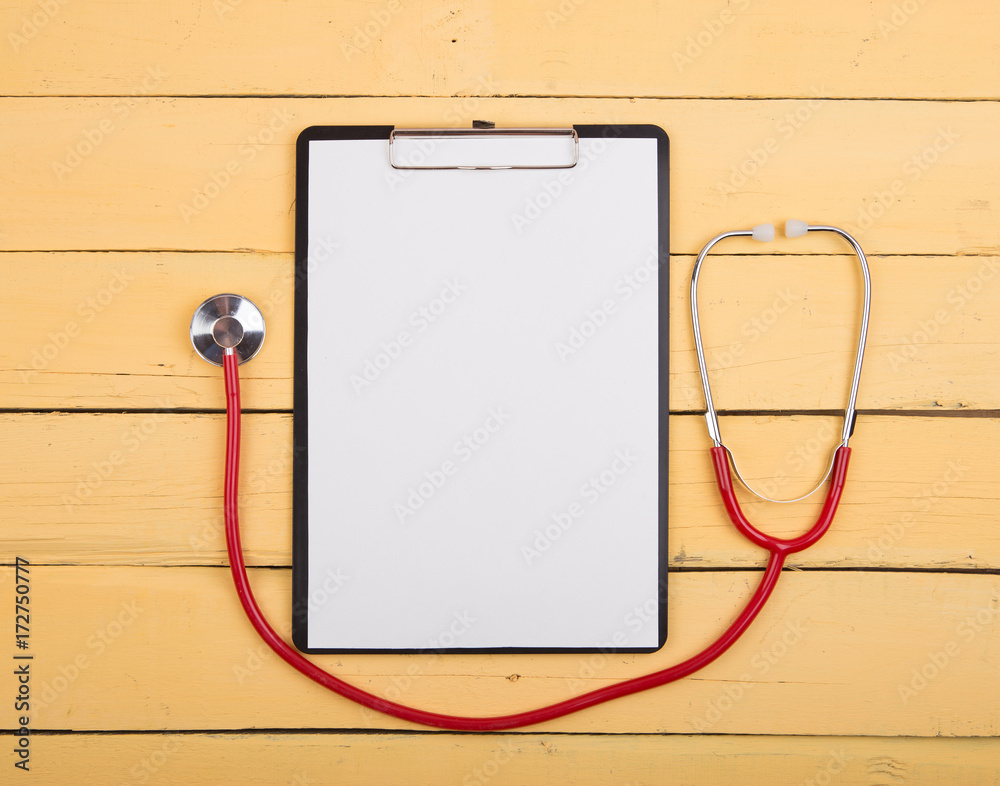 Wooden doctor desk background with stethoscope