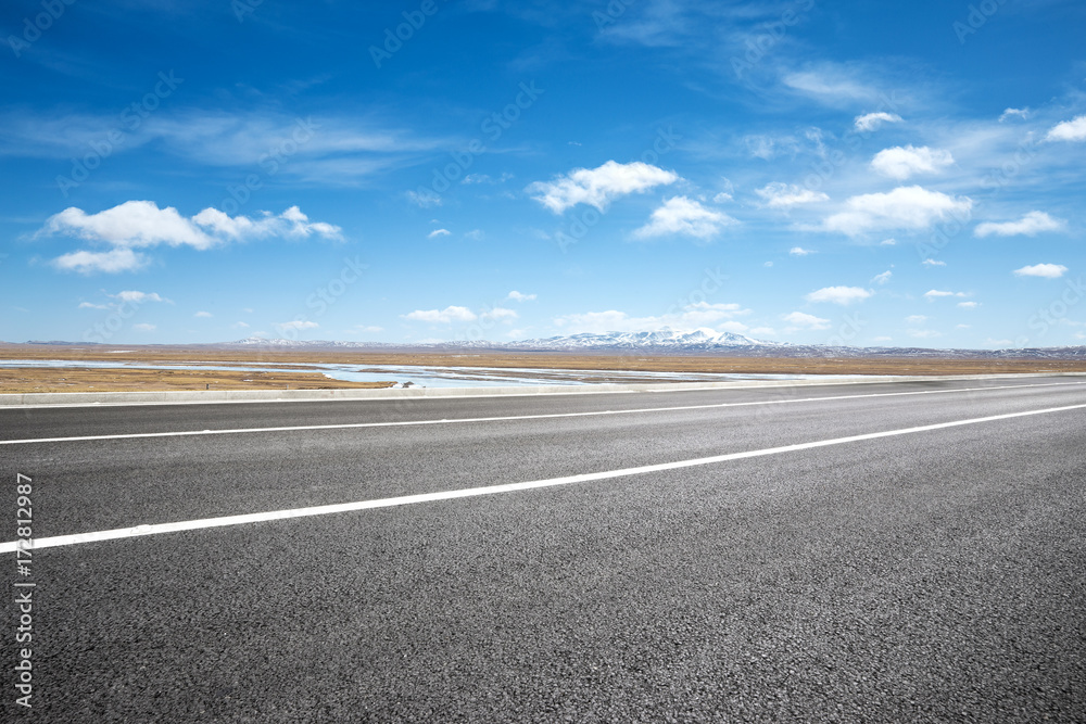 empty asphalt road with snow mountains