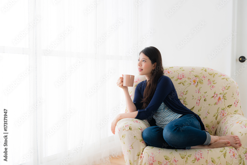 female student holding cup drinking hot coffee