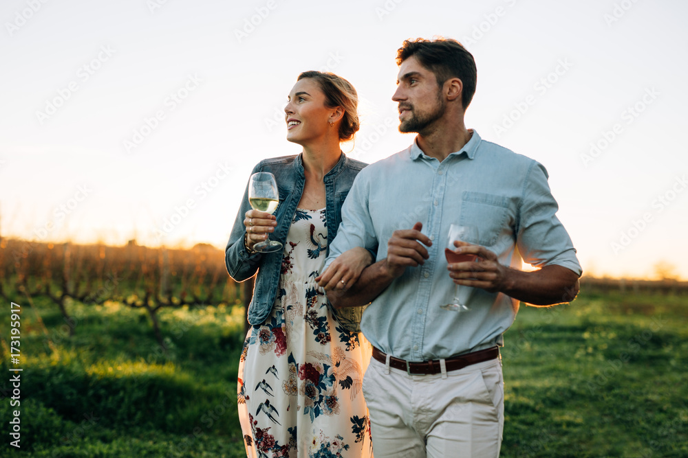 Couple with a glass of wine at vineyard outdoors