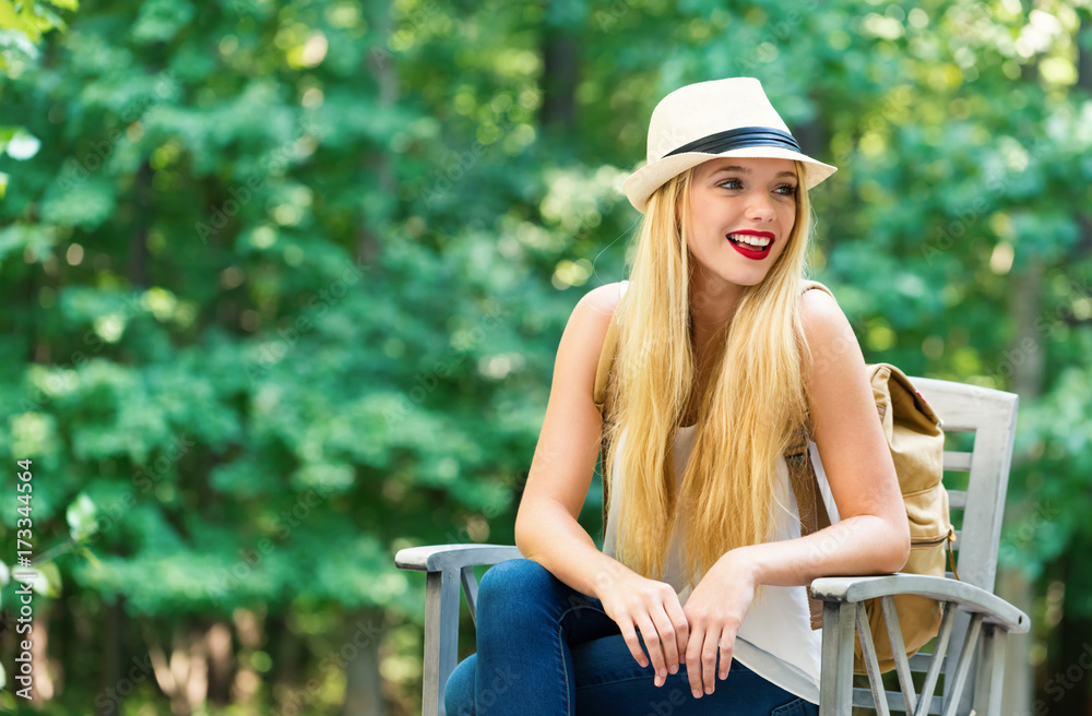 Young woman sitting outside on a beautiful summer day