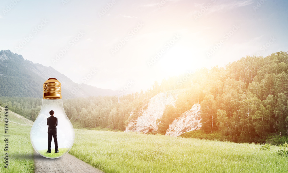 Businessman inside light bulb