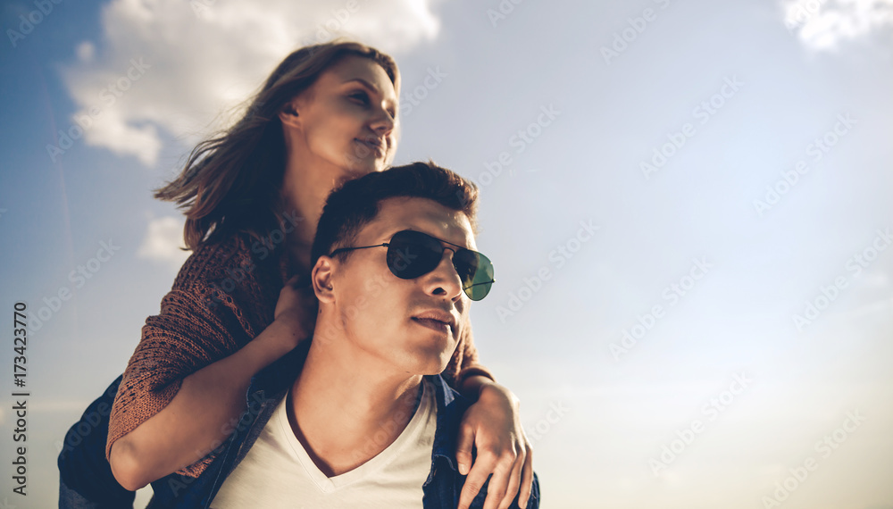 Happy couple having fun outdoor at sunset, love and friendship