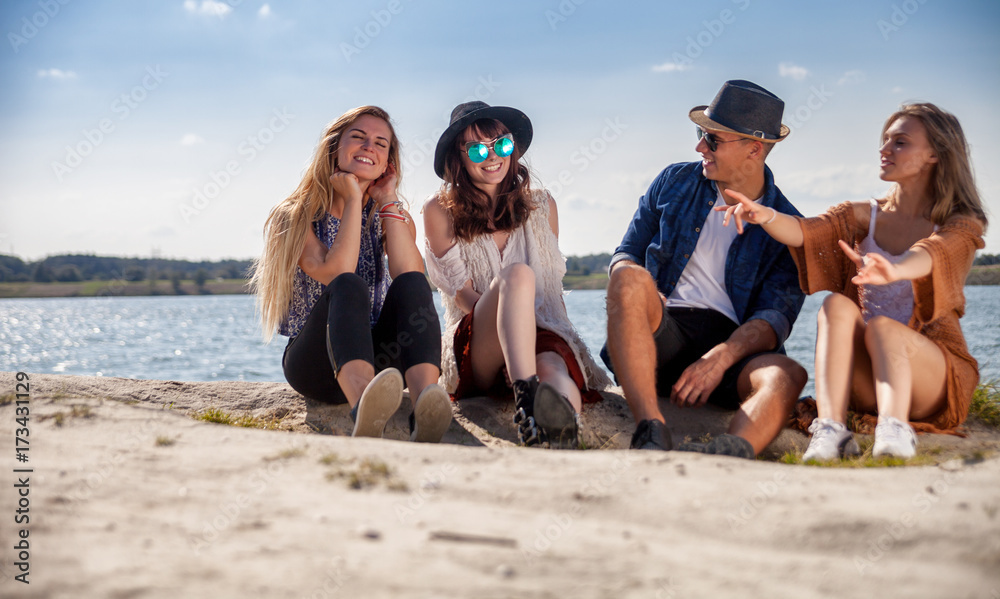 Friends having fun at the beach on sunny day, positive mood