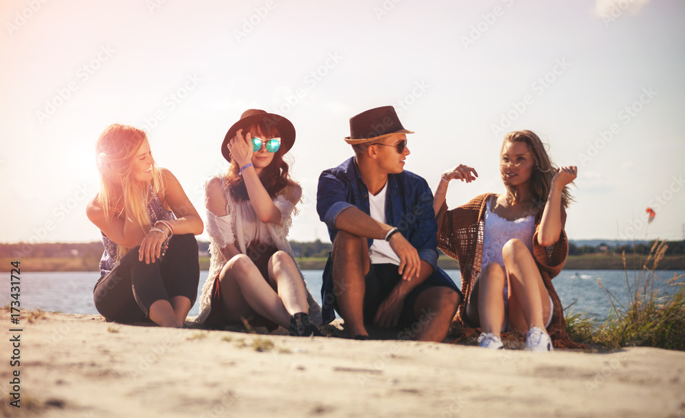 Friends having fun at the beach on sunny day, positive mood