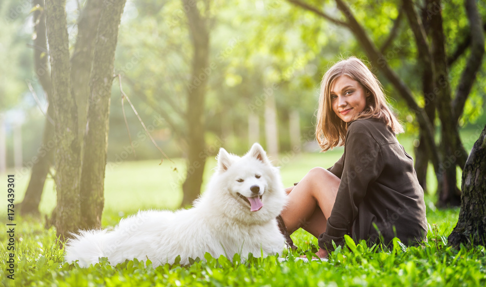 Samoyed dog with her owner at the park playing together