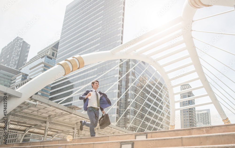 running business man in front of buildings hurry and rush because work late