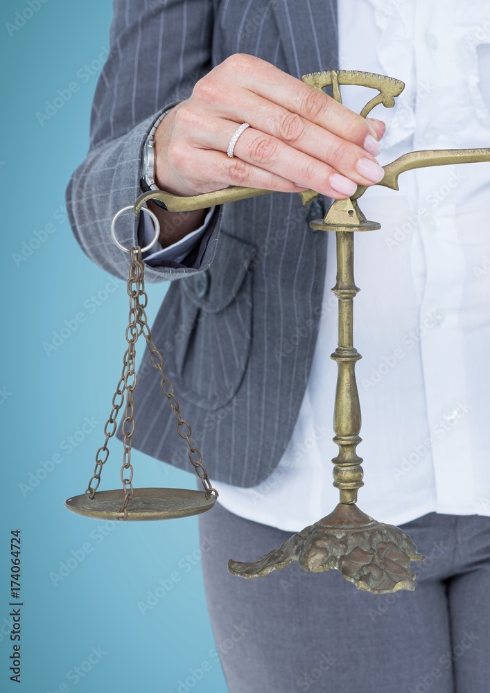 Female judge mid section with scales against blue background