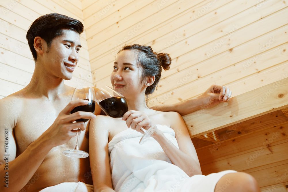 Couple, man and woman were sitting and drinking wine in the sauna, which I installed in their beauti