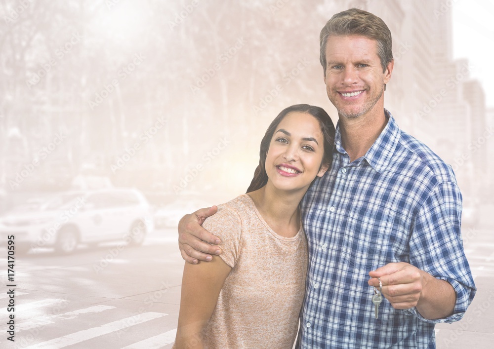 Couple  Holding key in front of street road cars