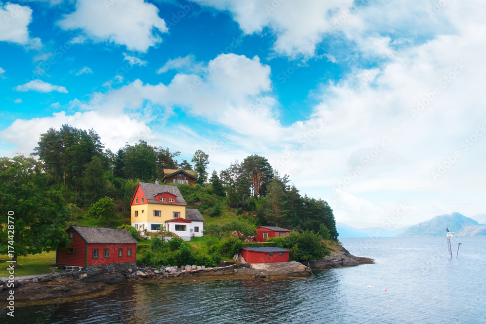 Typical norwegian landscape with red house