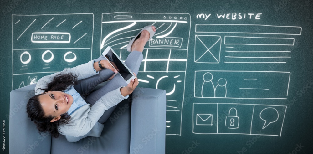 Composite image of woman on her tablet looking up