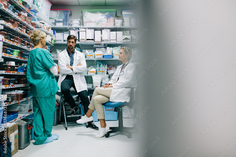 Hospital staff discussing medication in the pharmacy