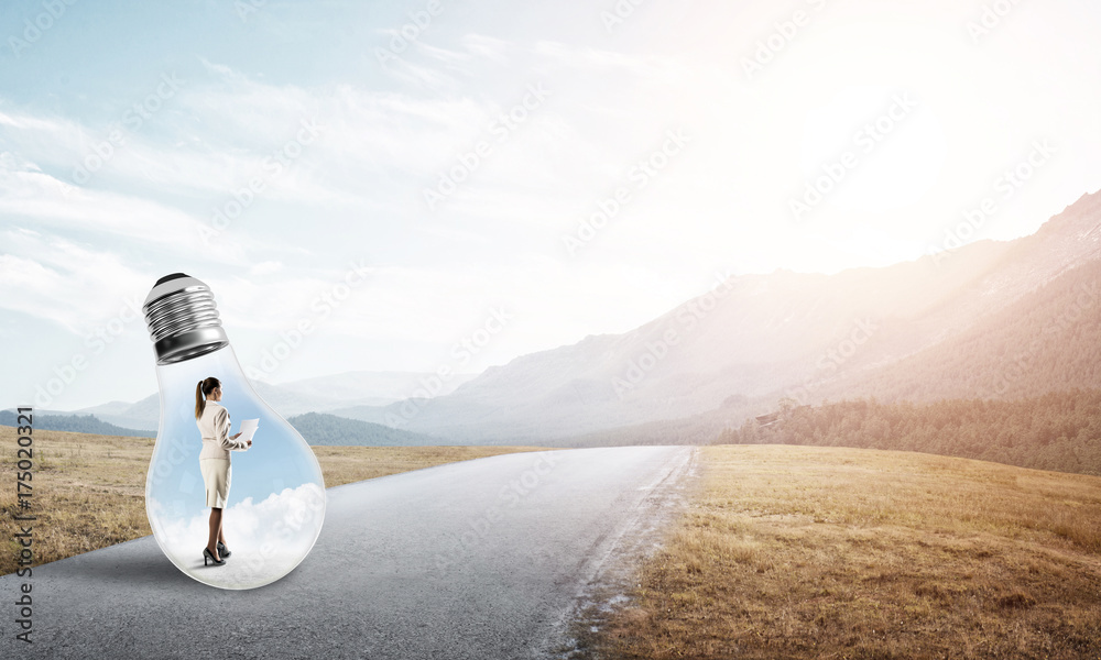 Businesswoman inside light bulb