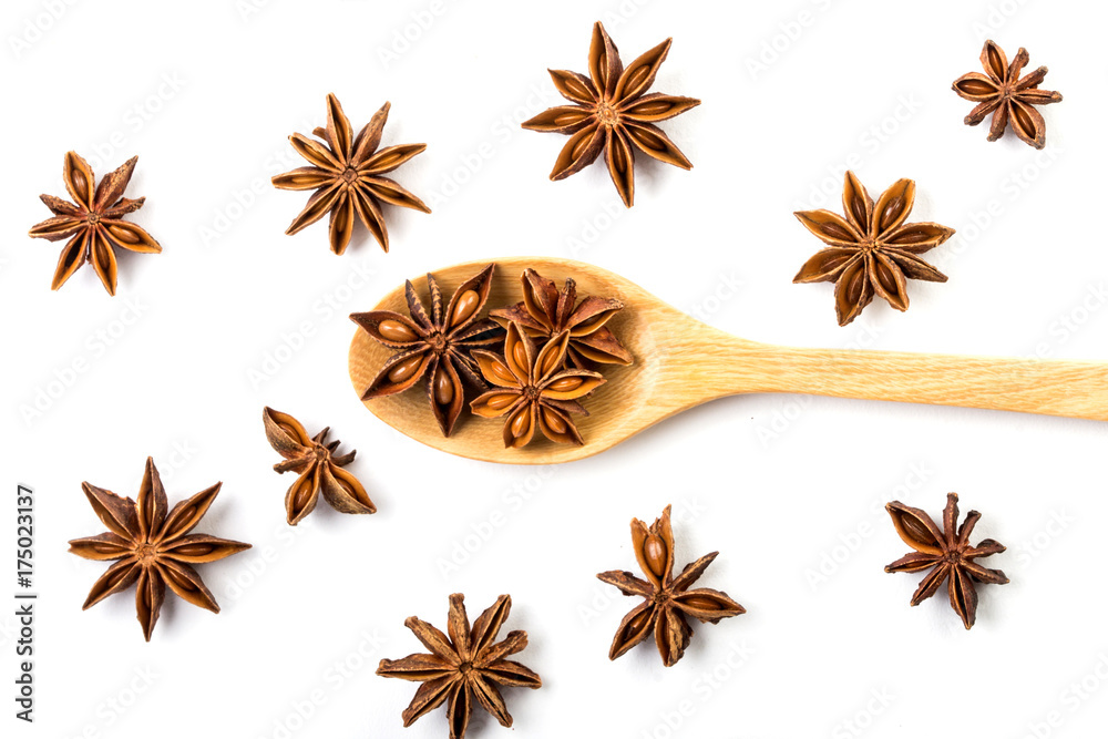 Close up the brown star anise spice in wooden spoon isolated on white background  and star anise pat