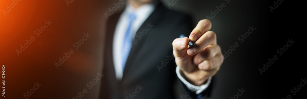 Panorama view of a businessman writing with a pen