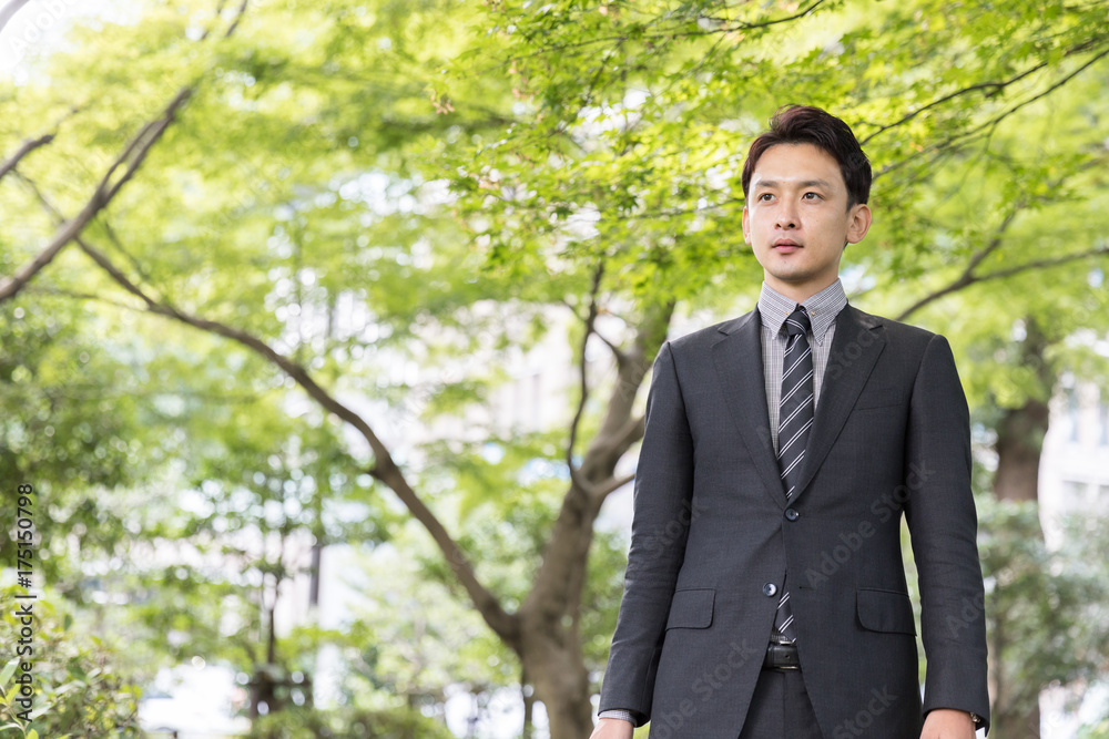 portrait of young asian businessman in park