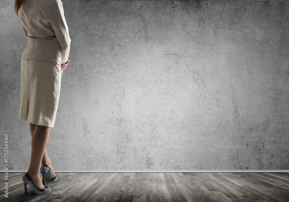 Businesswoman looking at wall