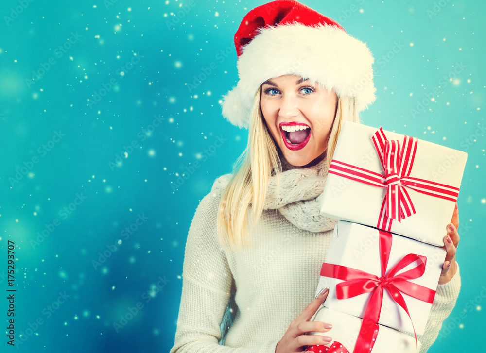 Happy young woman holding a stack of gift boxes