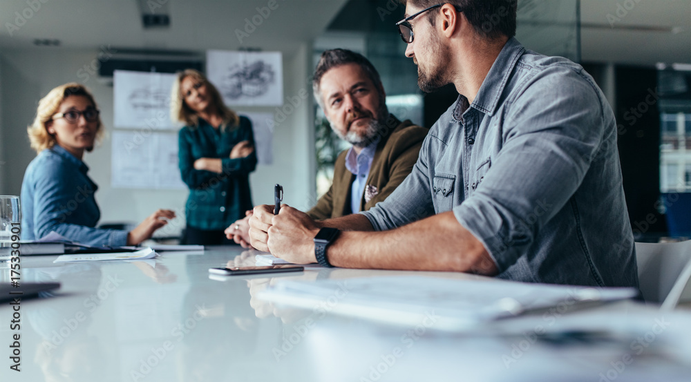 Businessman explaining new business ideas to peers