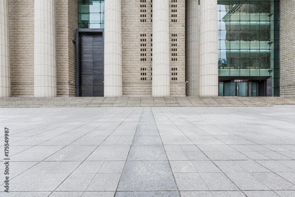 The square floor in front of the modern building