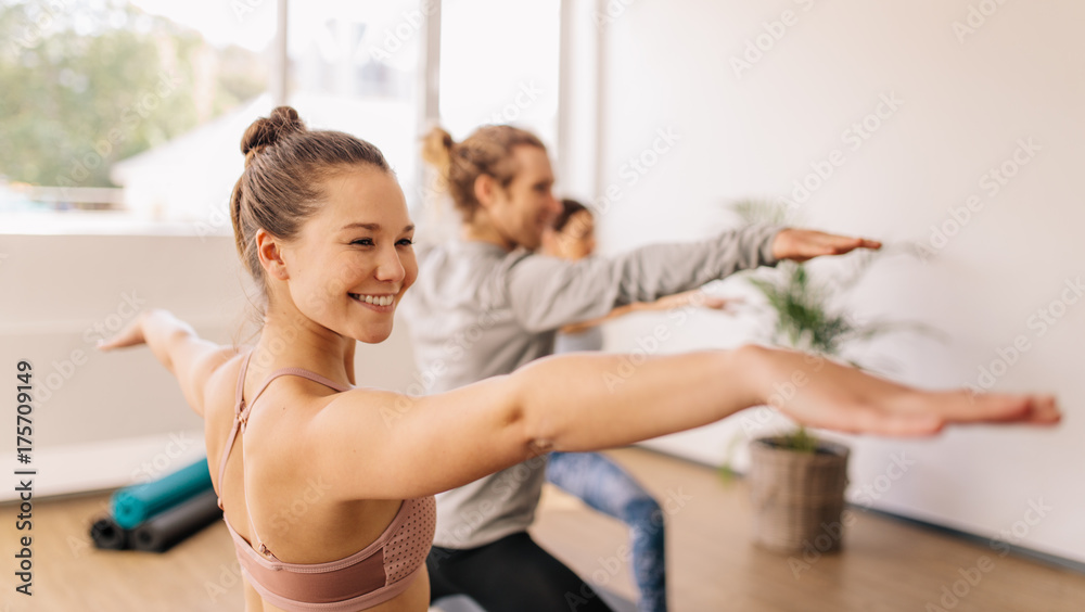 Woman practicing yoga at gym class