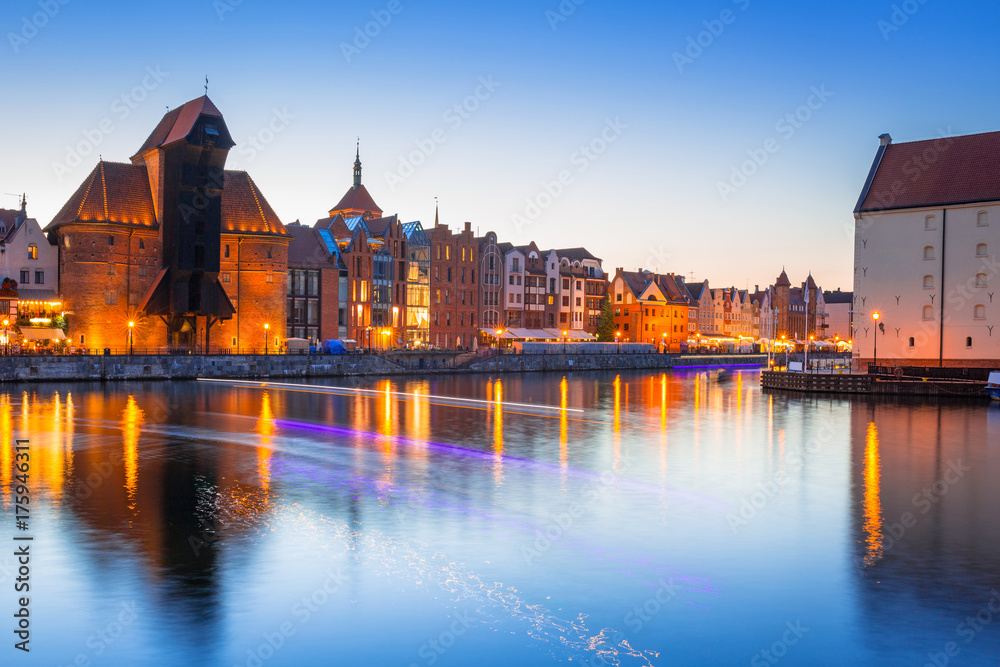 Gdansk at night with historic port crane reflected in Motlawa river, Poland