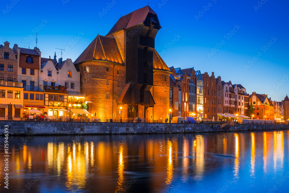 Gdansk at night with historic port crane reflected in Motlawa river, Poland