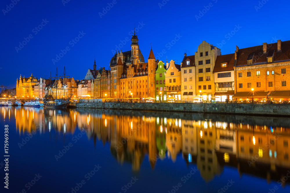 Old town of Gdansk at night reflected in Motlawa river, Poland