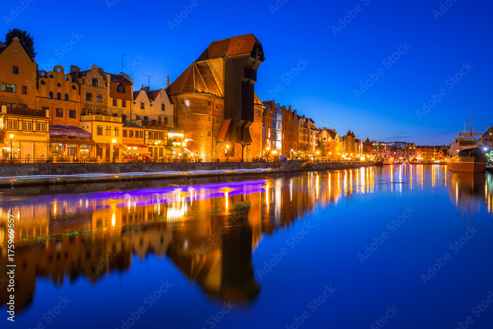 Gdansk at night with historic port crane reflected in Motlawa river, Poland