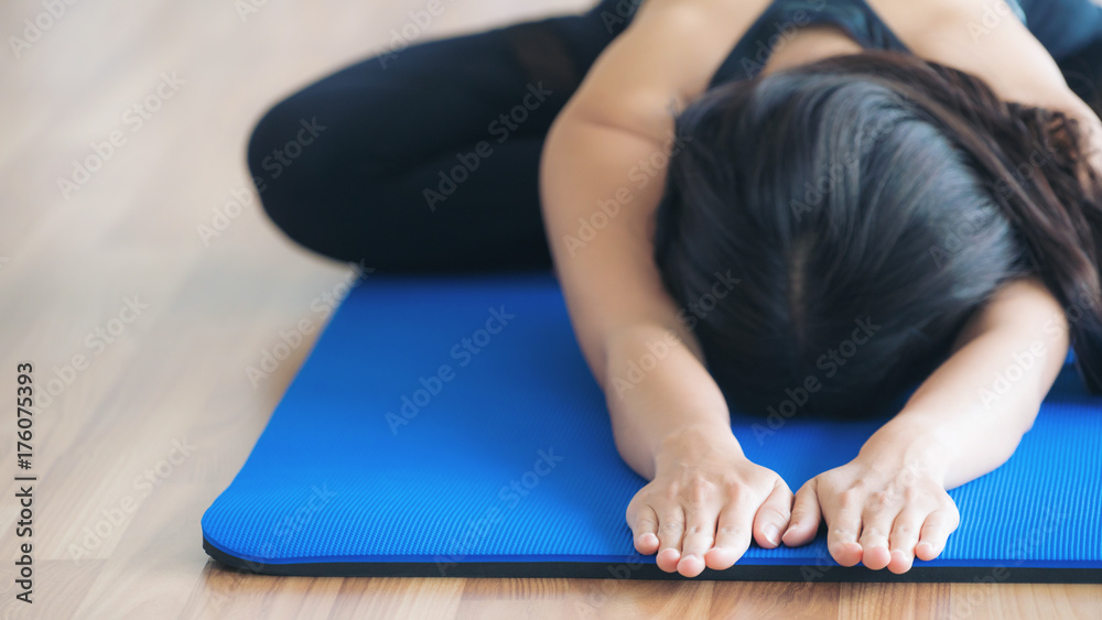 Woman practicing yoga pose in gym