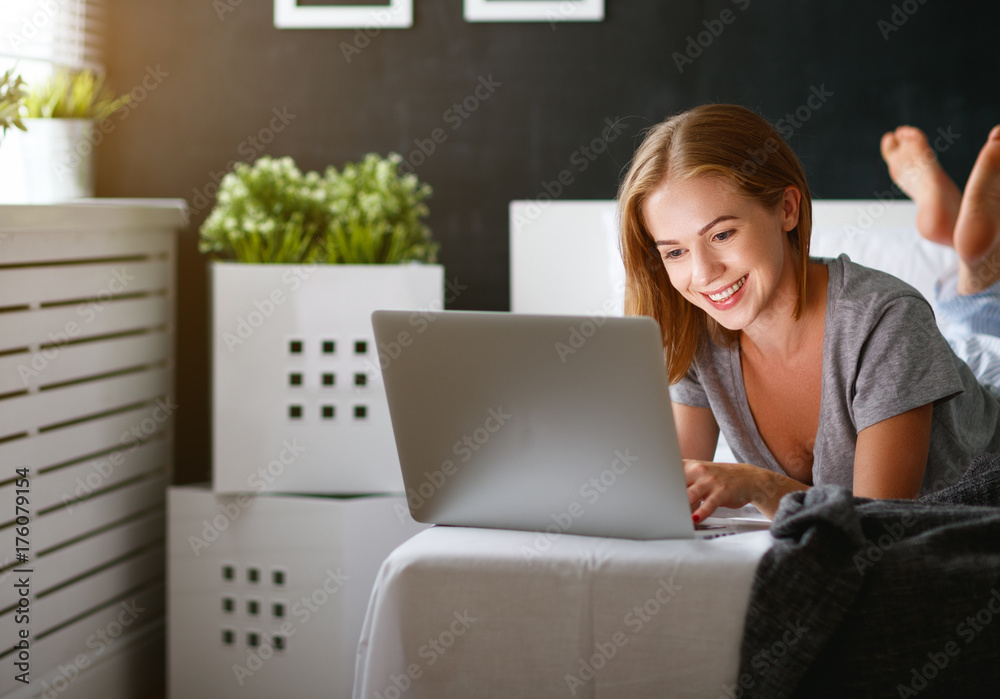 ng beautiful woman with  laptop and  cup of coffee in   morning in bed.