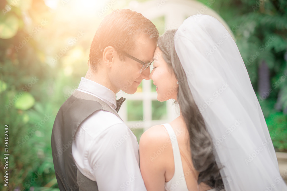 Groom and bride together. Wedding couple kiss and hug each other. focus on Flower bouquet