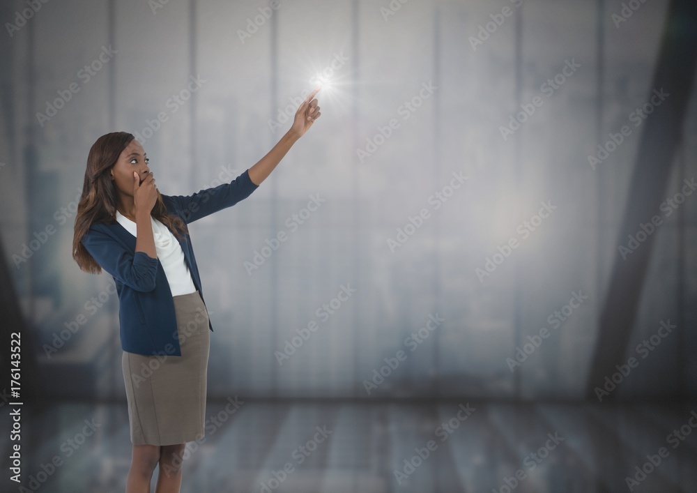 Businesswoman pointing by windows