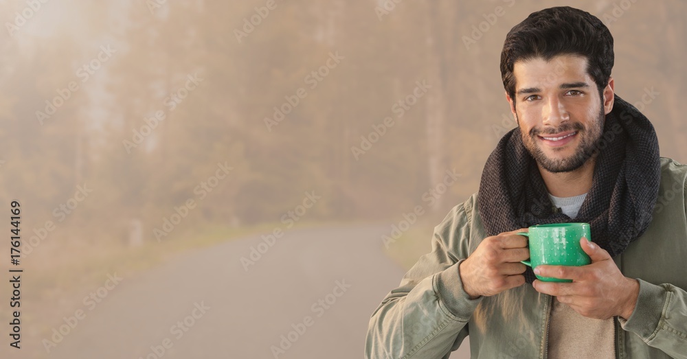 Man in Autumn with cup in toned forest