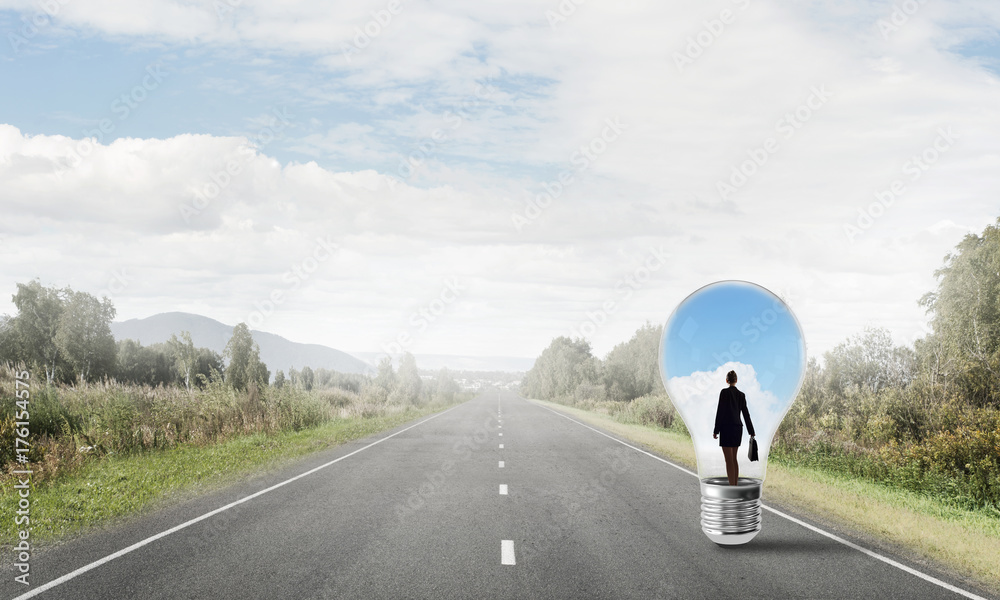 Businesswoman inside light bulb