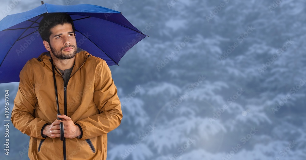 Man with blue umbrella in blue snow forest